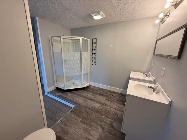 a bathroom with a sink toilet and mirror
