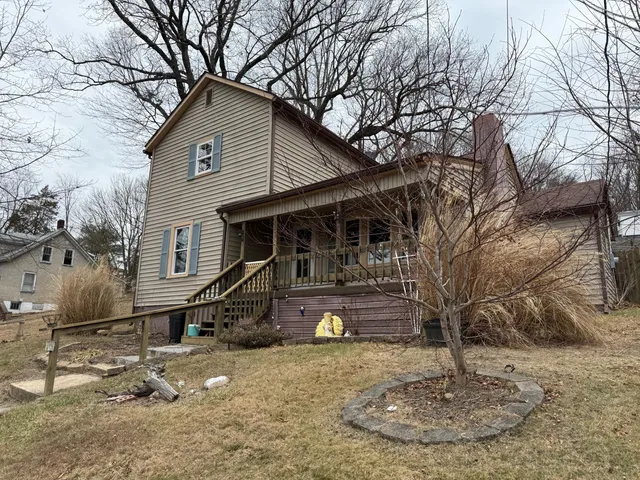 a view of a house with a yard covered in snow