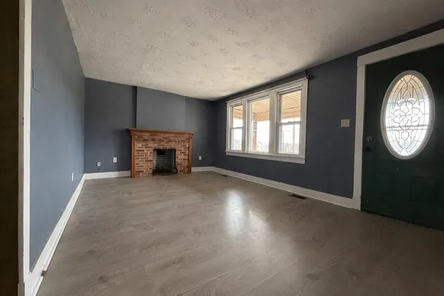 an empty room with windows and mountain view