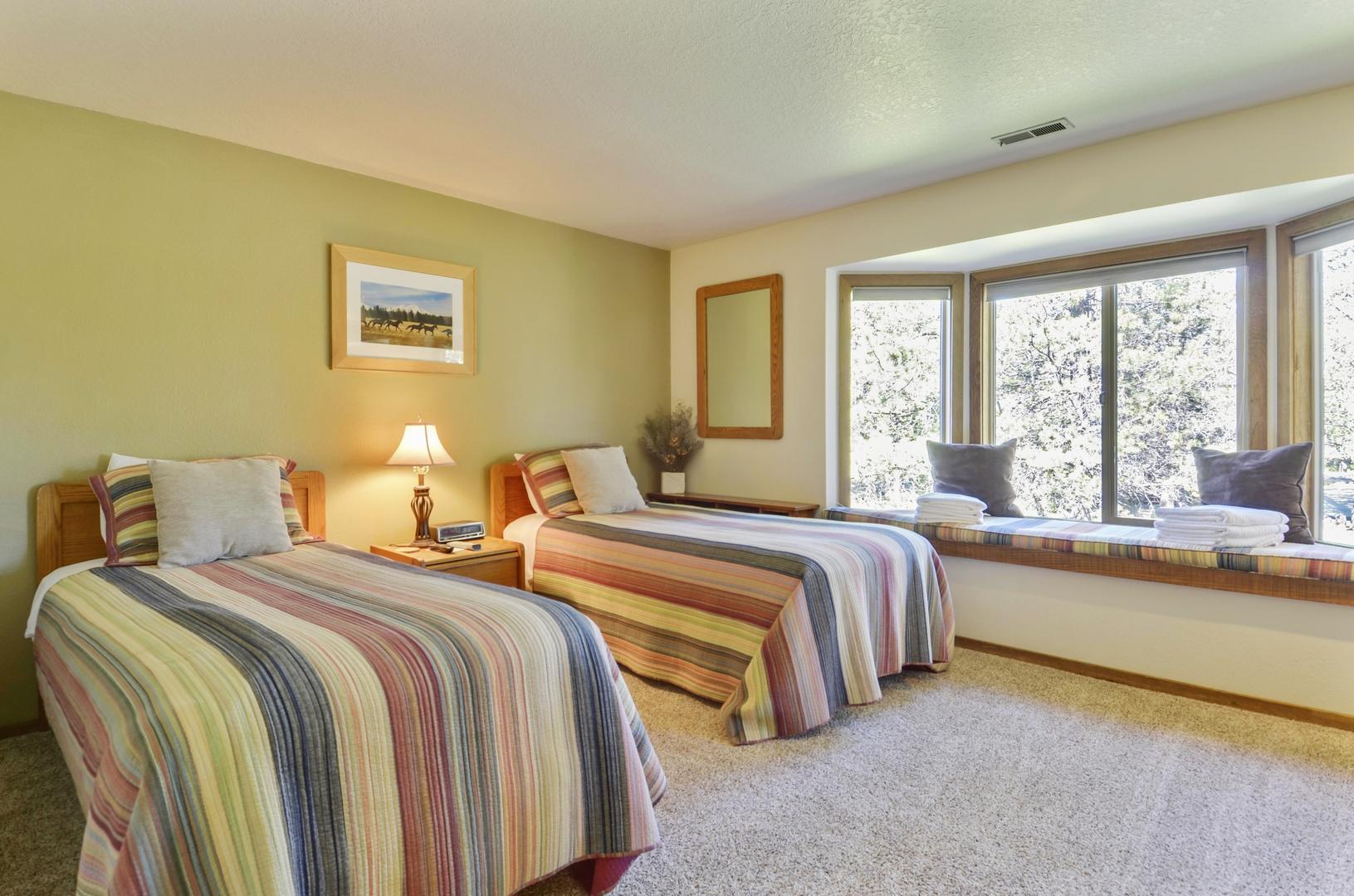 57301 Beaver Ridge Loop, Unit 10 Sunriver, OR 97707 - Photo 16 of 23 a bedroom with two beds and a large window