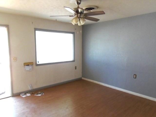 2218 Joliet Street Plainview, TX 79072 - Photo 4 of 9 an empty room with a window and a fan