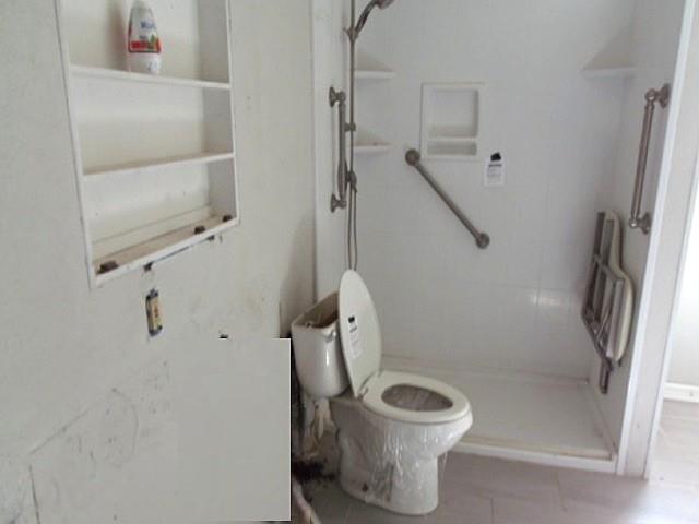 2218 Joliet Street Plainview, TX 79072 - Photo 8 of 9 a bathroom with a shower and a toilet