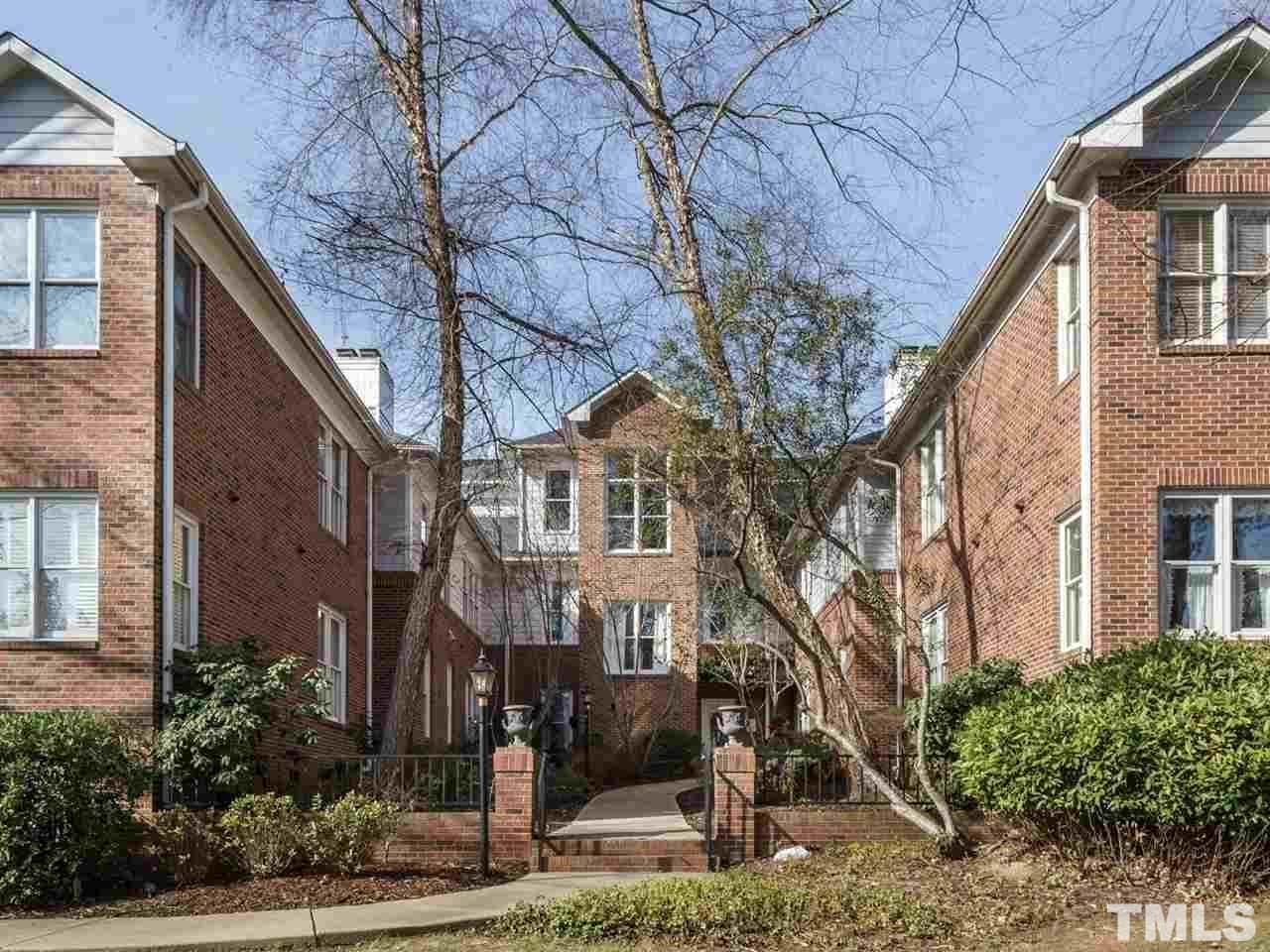 100 Edenburgh Road, Unit 102 Raleigh, NC 27608 - Photo 1 of 1 a view of a white house next to a yard