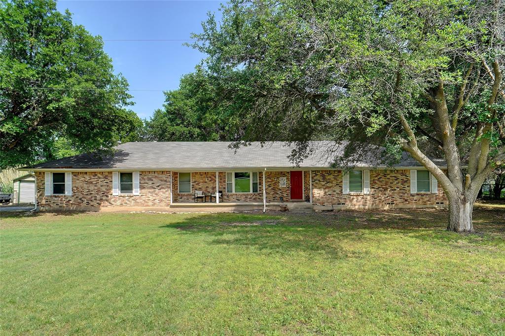 3977 Wakefield Road Justin, TX 76247 - Photo 1 of 1 Ranch-style home featuring brick siding and a front lawn
