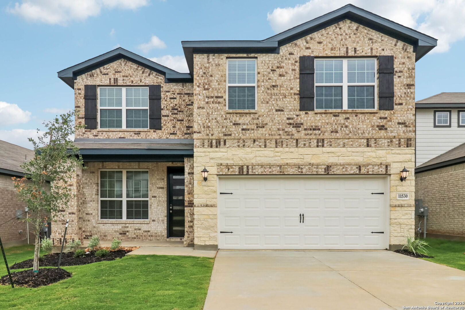 a front view of a house with garden