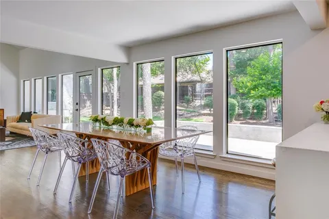 a view of a dining room with furniture window and wooden floor