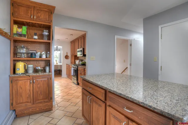 a kitchen with stainless steel appliances granite countertop a refrigerator and stove