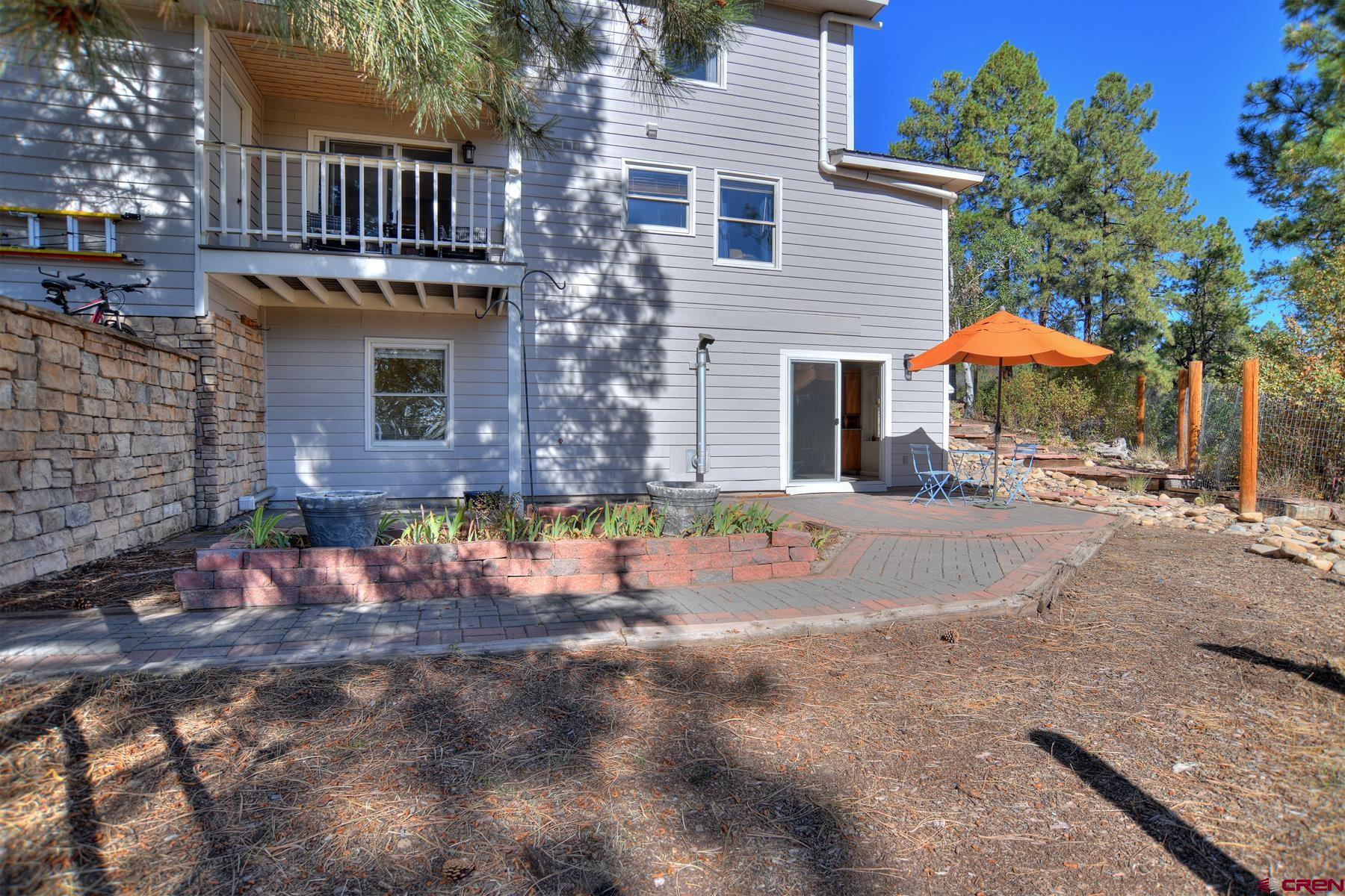 1172 Ridge Road Durango, CO 81303 - Photo 18 of 43 a view of a white house with a yard and sitting area