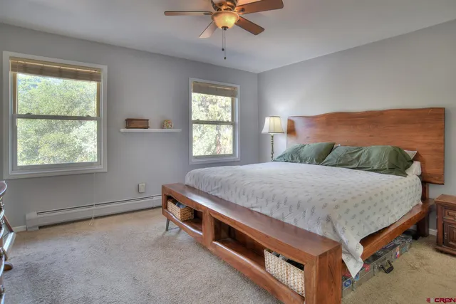 a spacious bedroom with a bed and a window