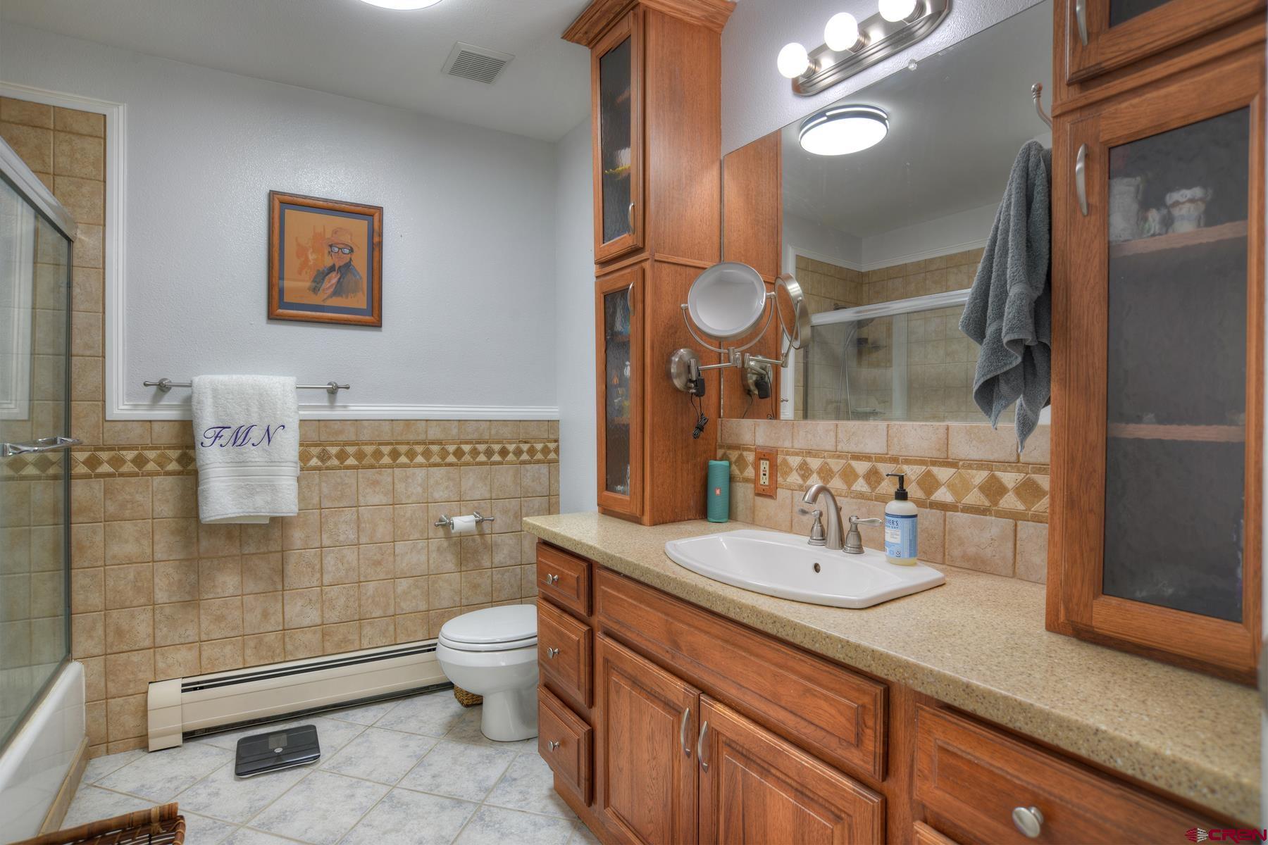 1172 Ridge Road Durango, CO 81303 - Photo 28 of 43 a bathroom with a sink a toilet a mirror and shower