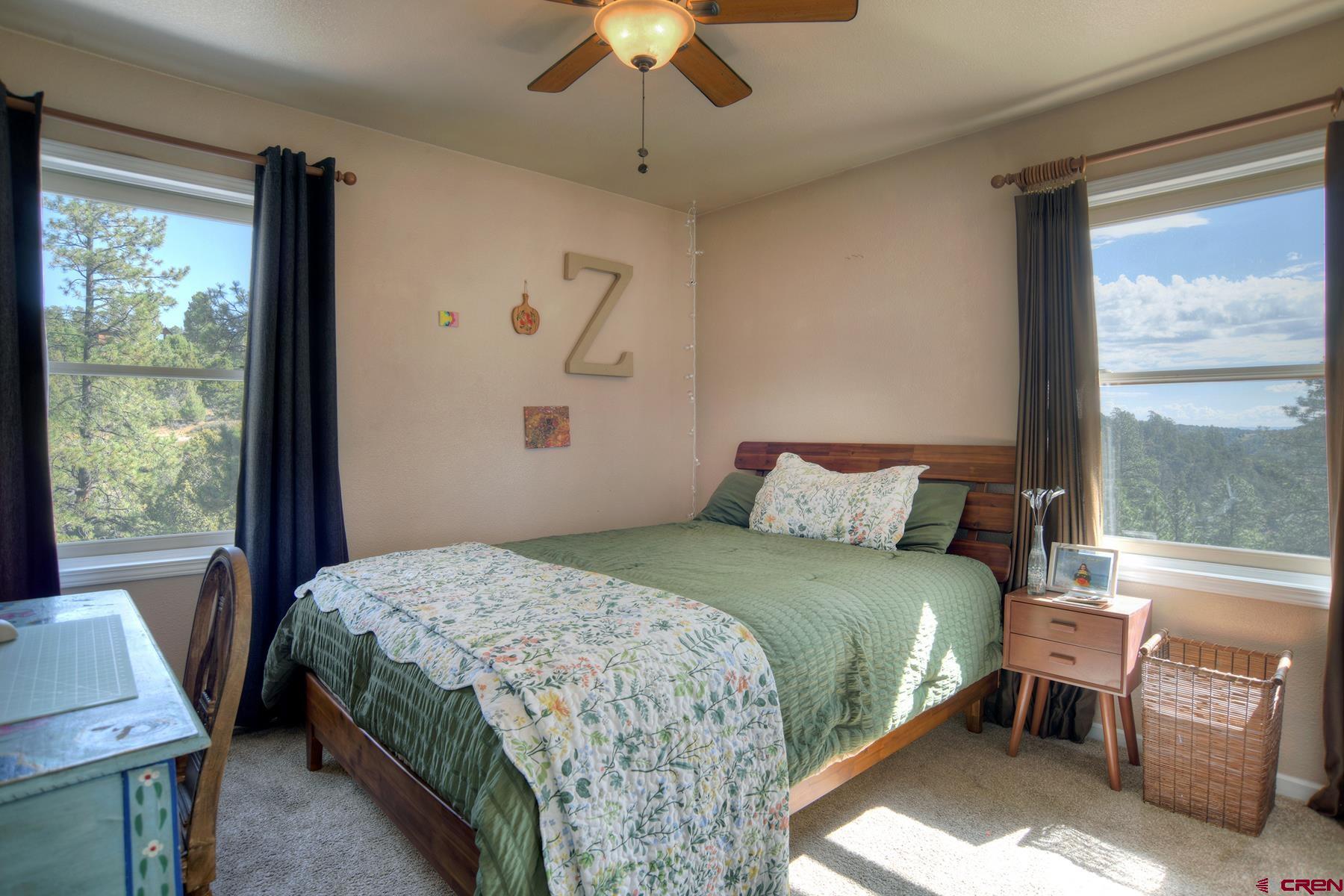 1172 Ridge Road Durango, CO 81303 - Photo 30 of 43 a bedroom with a bed and a window