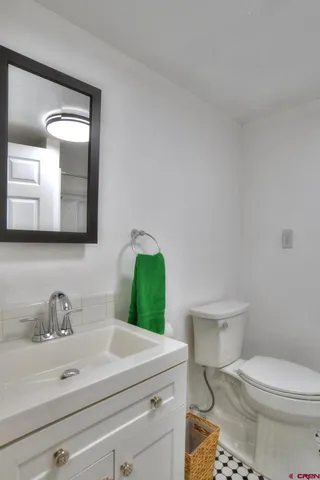 a bathroom with a toilet sink and mirror