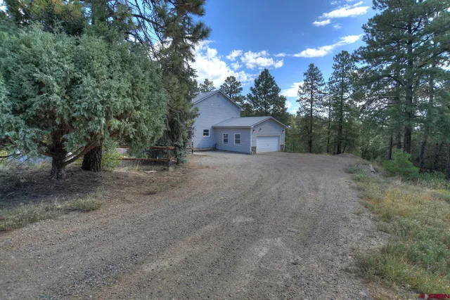 a view of a house with a tree and a yard