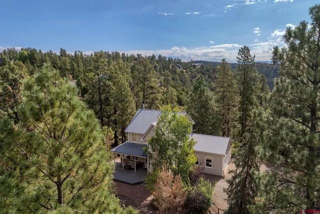 an aerial view of a house with a yard