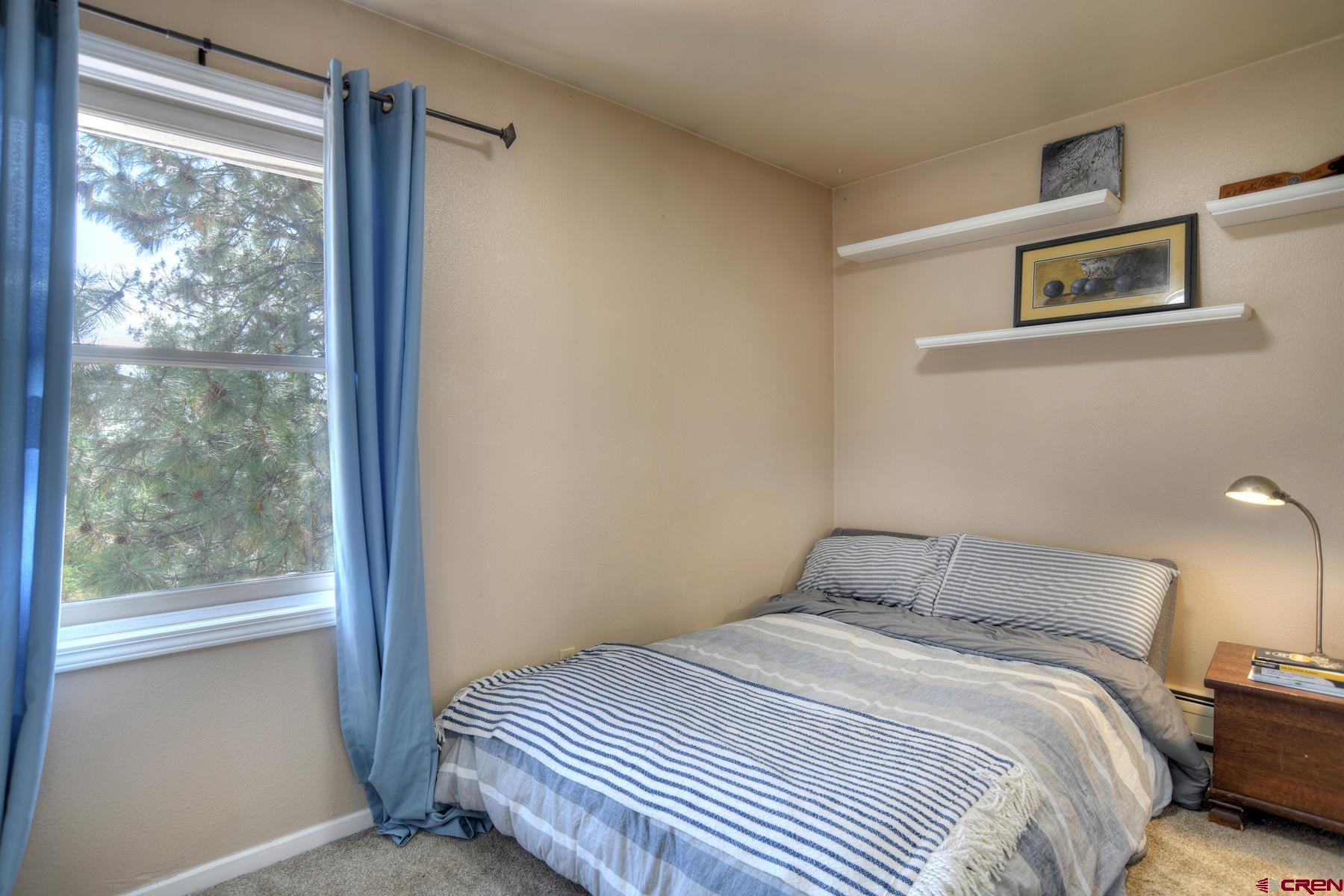 1172 Ridge Road Durango, CO 81303 - Photo 7 of 43 a bedroom with a bed and a window