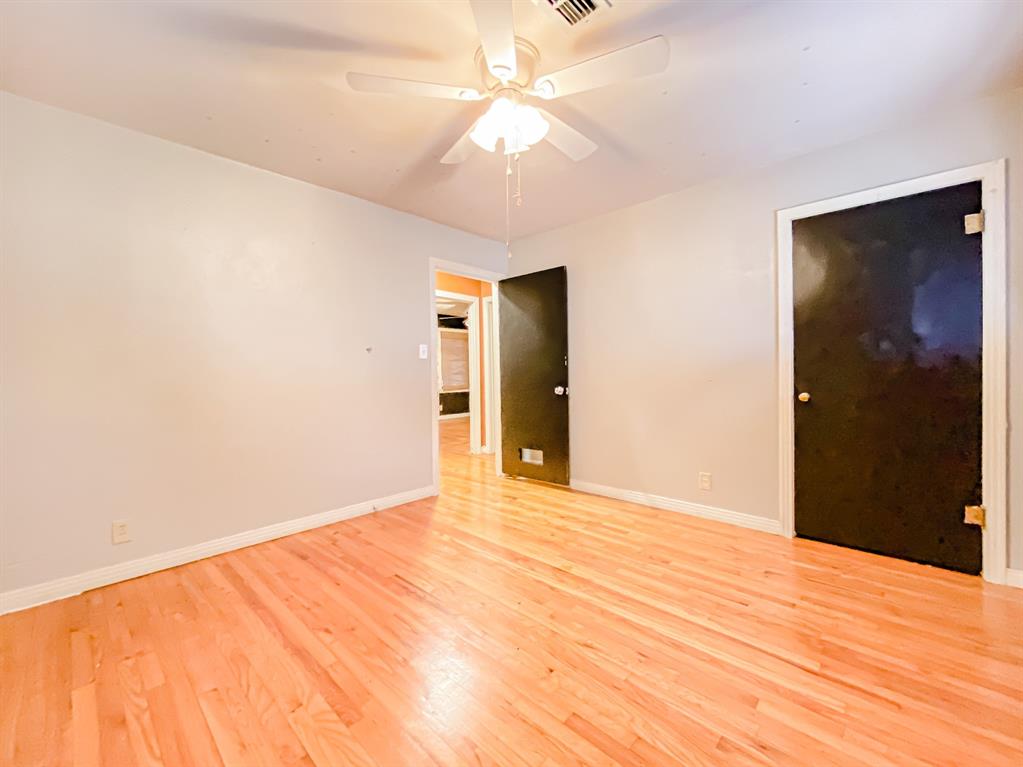 211 Paloma Street Winters, TX 79567 - Photo 13 of 19 a view of an empty room with a ceiling fan