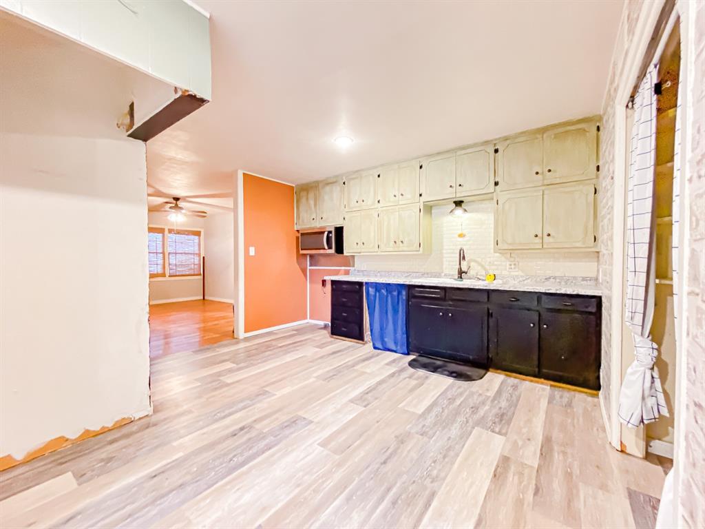 211 Paloma Street Winters, TX 79567 - Photo 5 of 19 a kitchen with stainless steel appliances kitchen island granite countertop a refrigerator and cabinets