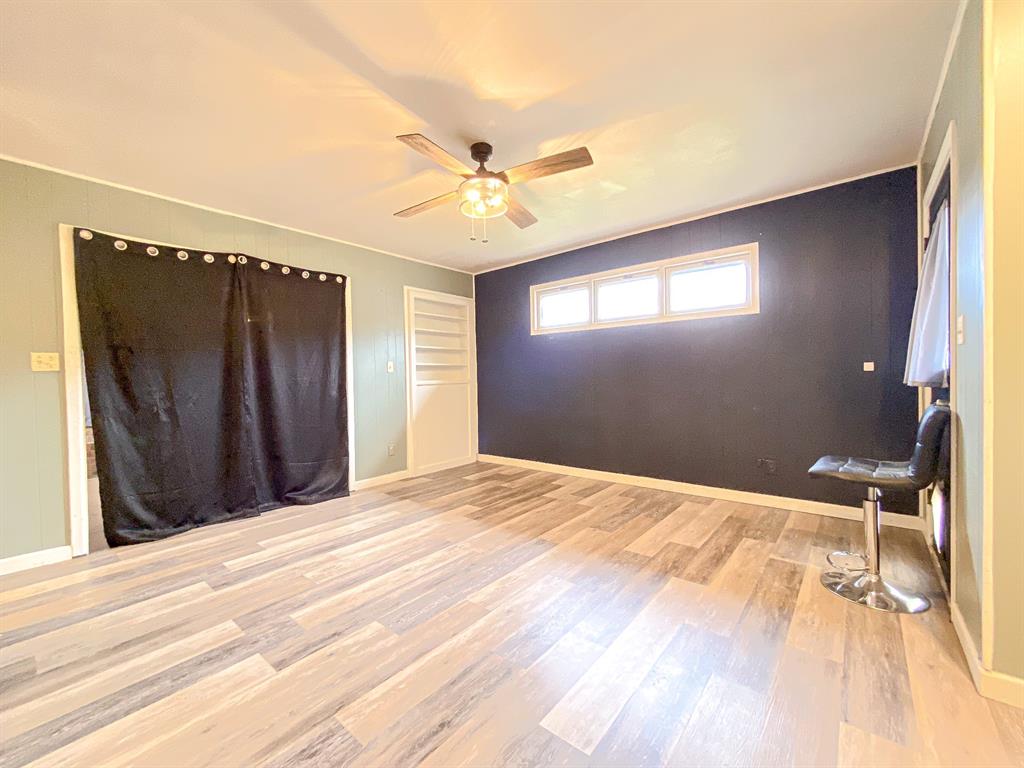 211 Paloma Street Winters, TX 79567 - Photo 6 of 19 a bedroom with a bed and a chandelier