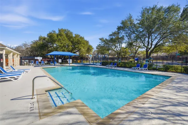 a swimming pool with outdoor seating and yard