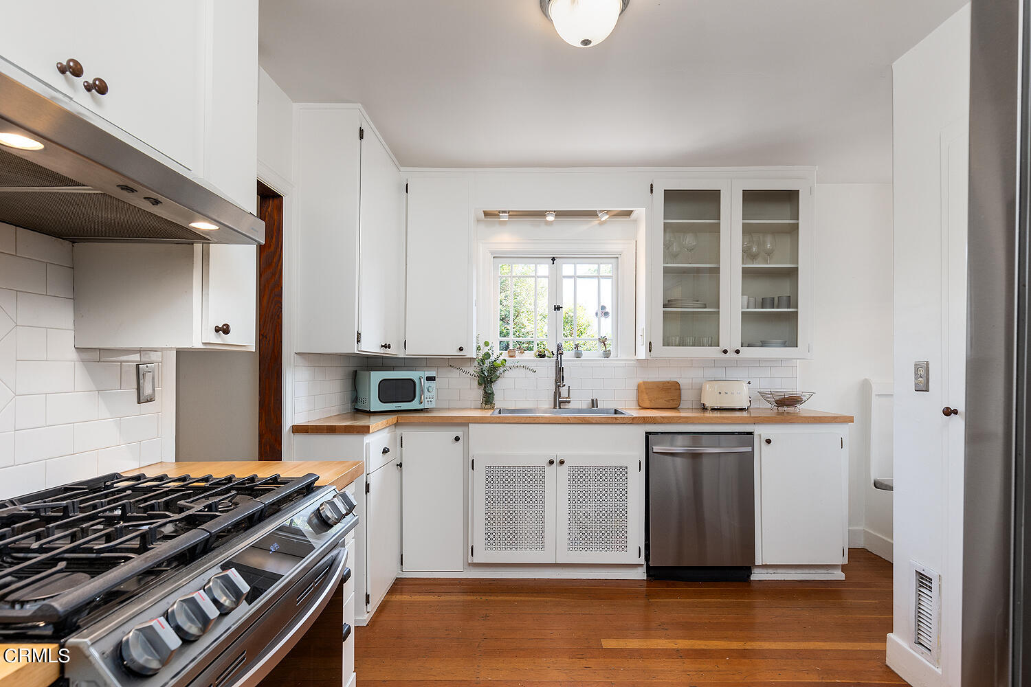 546 Douglas Street Pasadena, CA 91104 - Photo 14 of 36 a kitchen with stainless steel appliances a sink a stove and cabinets