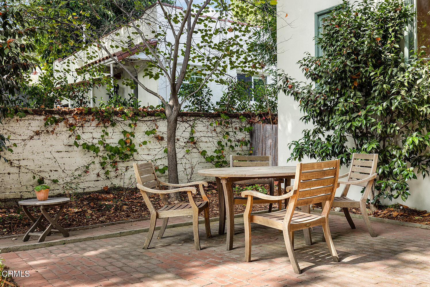 546 Douglas Street Pasadena, CA 91104 - Photo 27 of 36 a patio with table and chairs and potted plants
