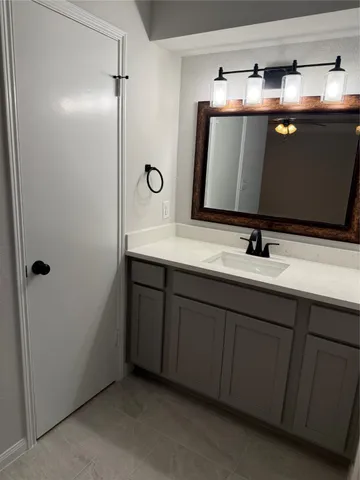 a bathroom with a double vanity sink and mirror