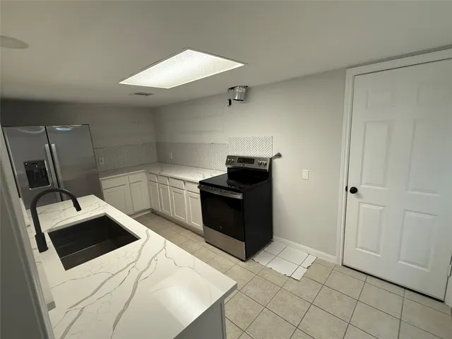 a kitchen with a stove and a refrigerator