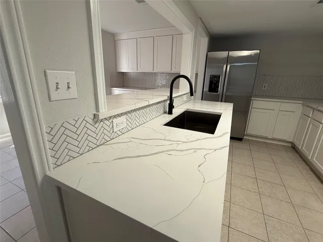 a close view of a sink a washer and dryer