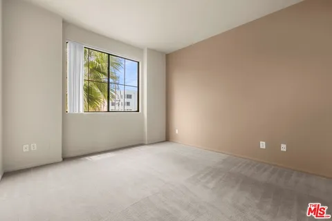 an empty room with windows and closet