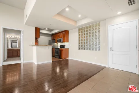 a view of a kitchen with a sink and a refrigerator