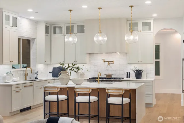 a kitchen with a table chairs sink and cabinets