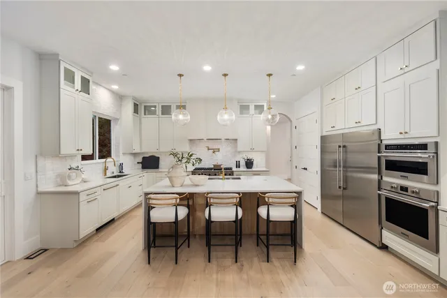 a large kitchen with a table and chairs