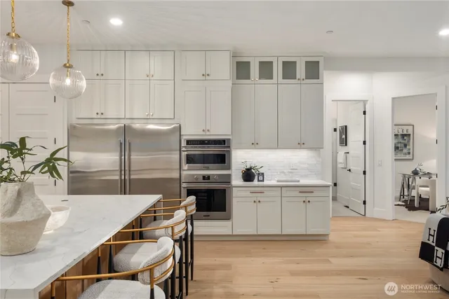 a kitchen with kitchen island a counter top space appliances and cabinets