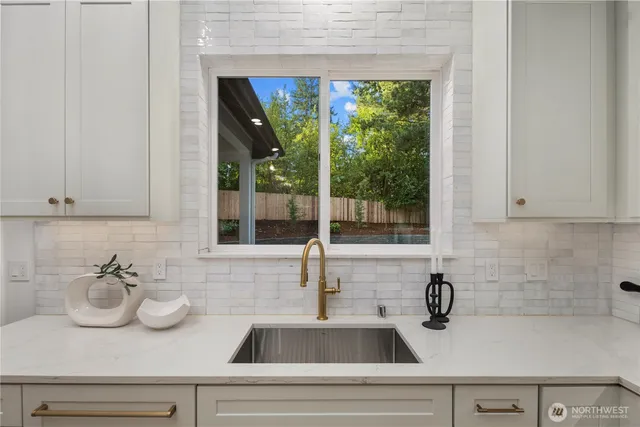 a kitchen with a sink and large window