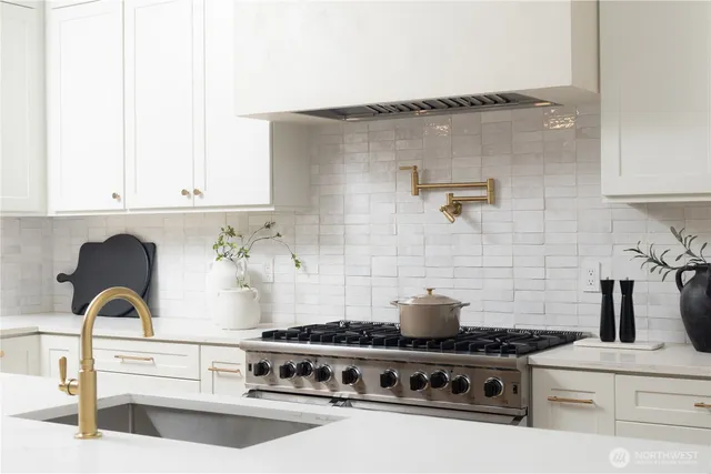 a white stove top oven sitting inside of a kitchen