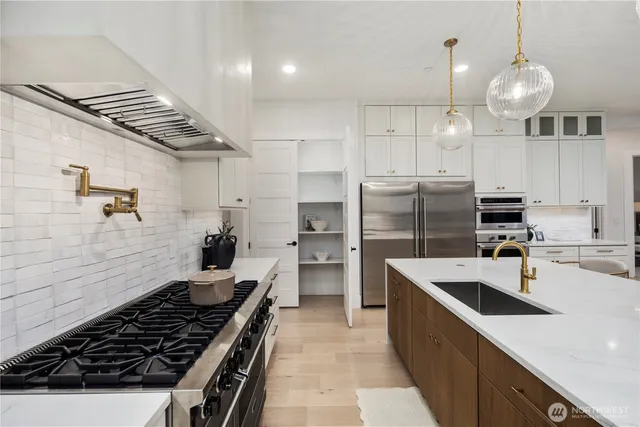 a kitchen with refrigerator and stove