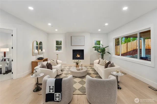 a living room with fireplace furniture and a wooden floor