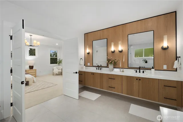 a large white kitchen with a sink and dishwasher with white cabinets