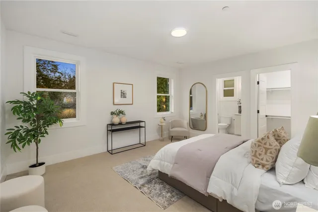 a bedroom with a bed and a potted plant
