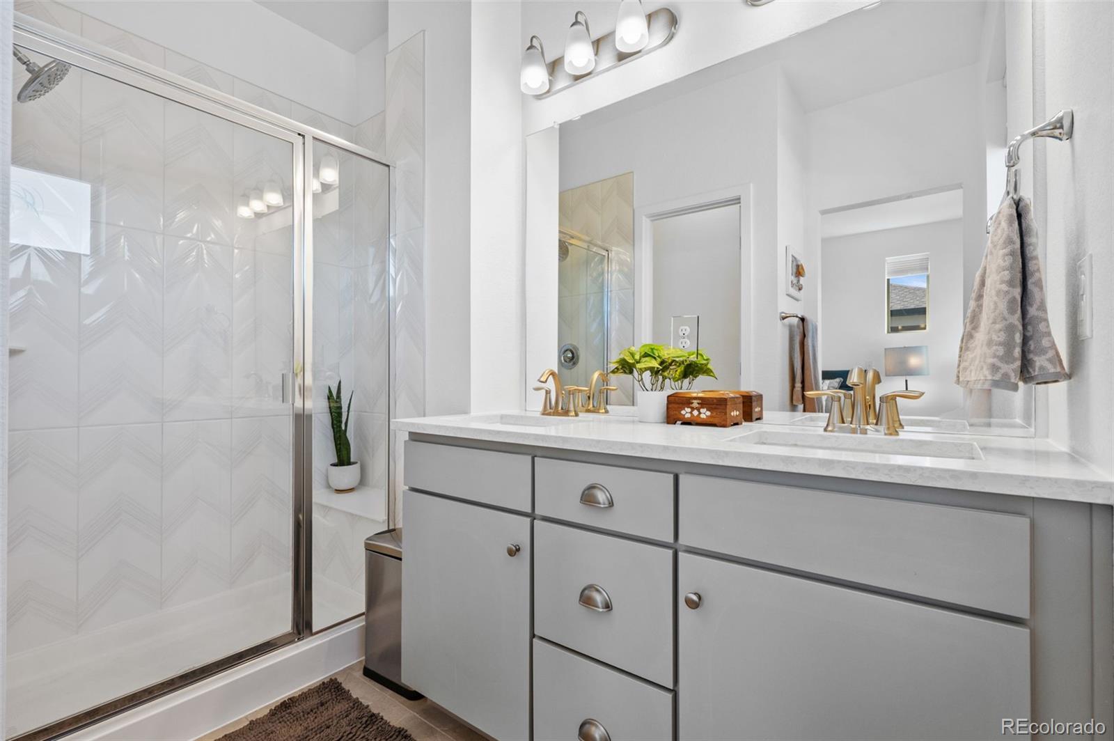 6817 Clay Street Denver, CO 80221 - Photo 17 of 41 a bathroom with a double vanity sink mirror and shower