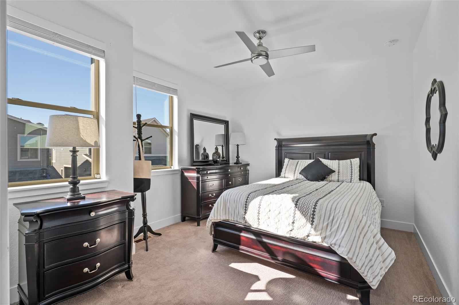 6817 Clay Street Denver, CO 80221 - Photo 20 of 41 a bedroom with a bed and furniture