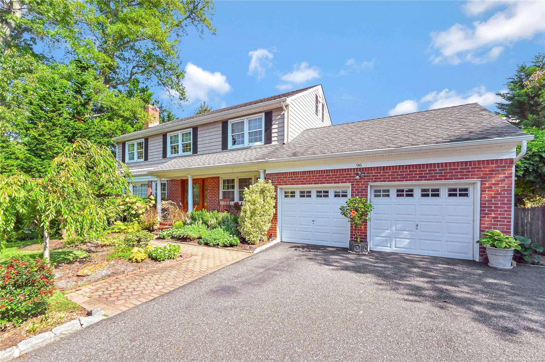 96 Little Neck Road Centerport, NY 11721 - Photo 1 of 1 a front view of a house with a yard and garage