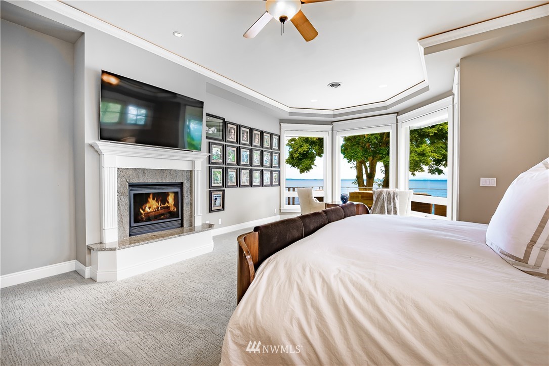 8745 Oertel Drive Blaine, WA 98230 - Photo 16 of 40 a spacious bedroom with a large bed and a fireplace