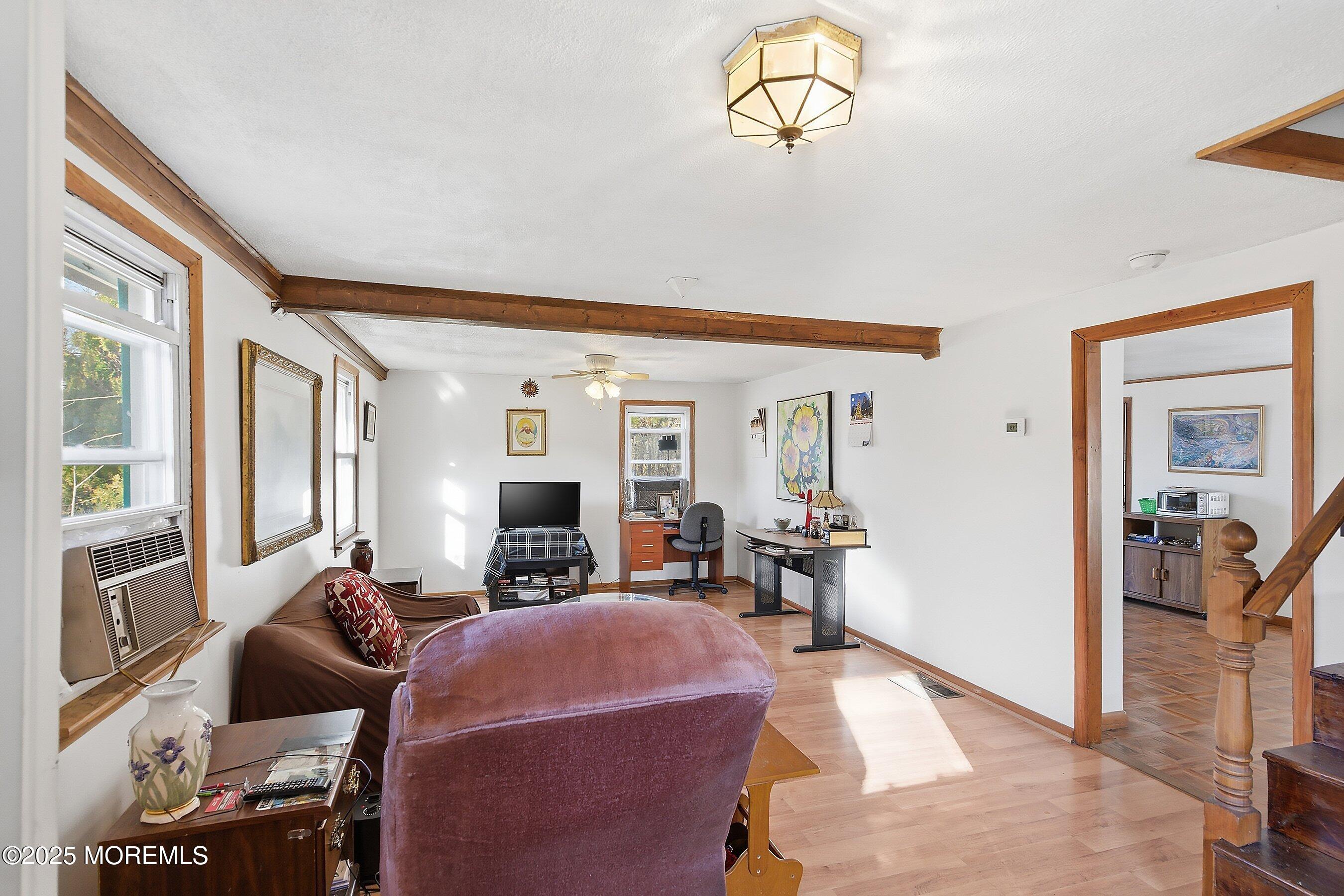 491 Lakehurst Road Browns Mills, NJ 08015 - Photo 6 of 15 a living room with furniture chandelier and a large window