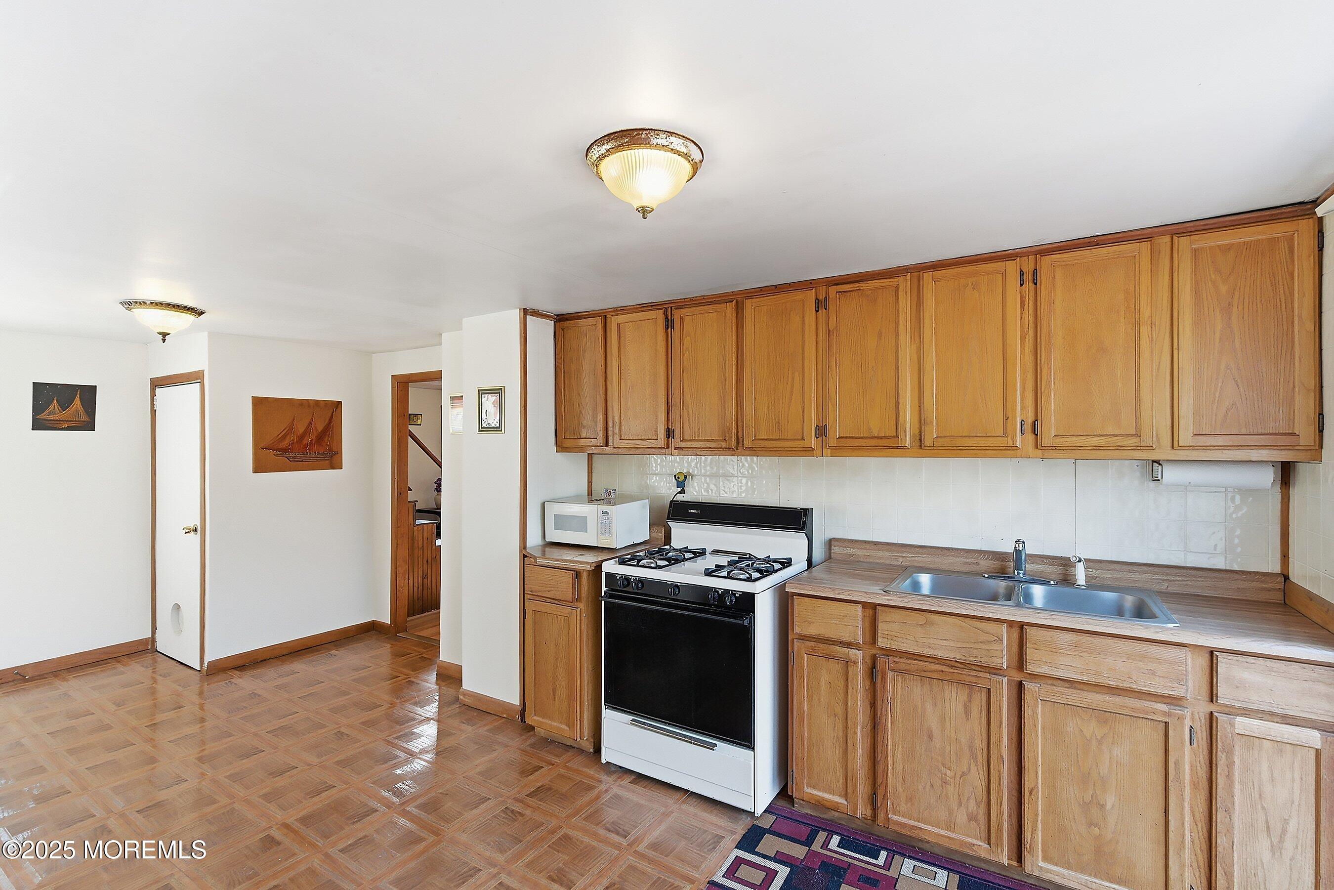 491 Lakehurst Road Browns Mills, NJ 08015 - Photo 8 of 15 a kitchen with stainless steel appliances granite countertop a stove a sink and a refrigerator