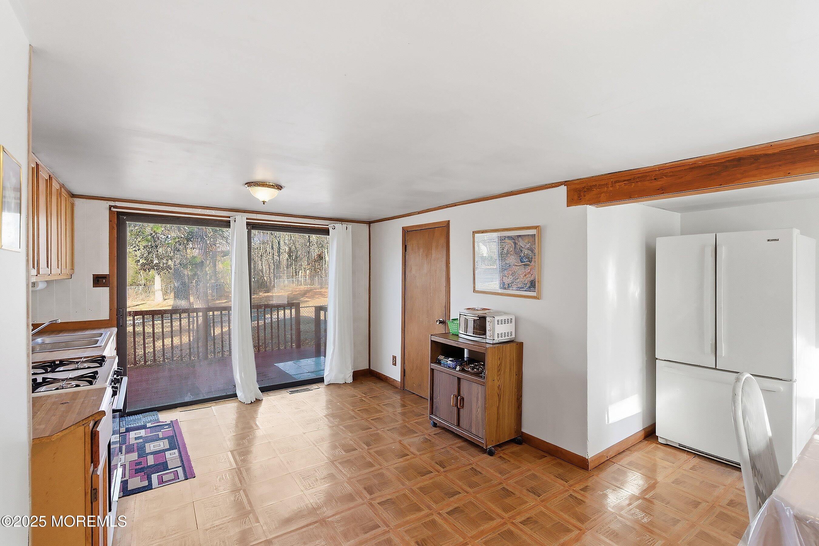 491 Lakehurst Road Browns Mills, NJ 08015 - Photo 10 of 15 a spacious bedroom with a balcony a bed and a large window