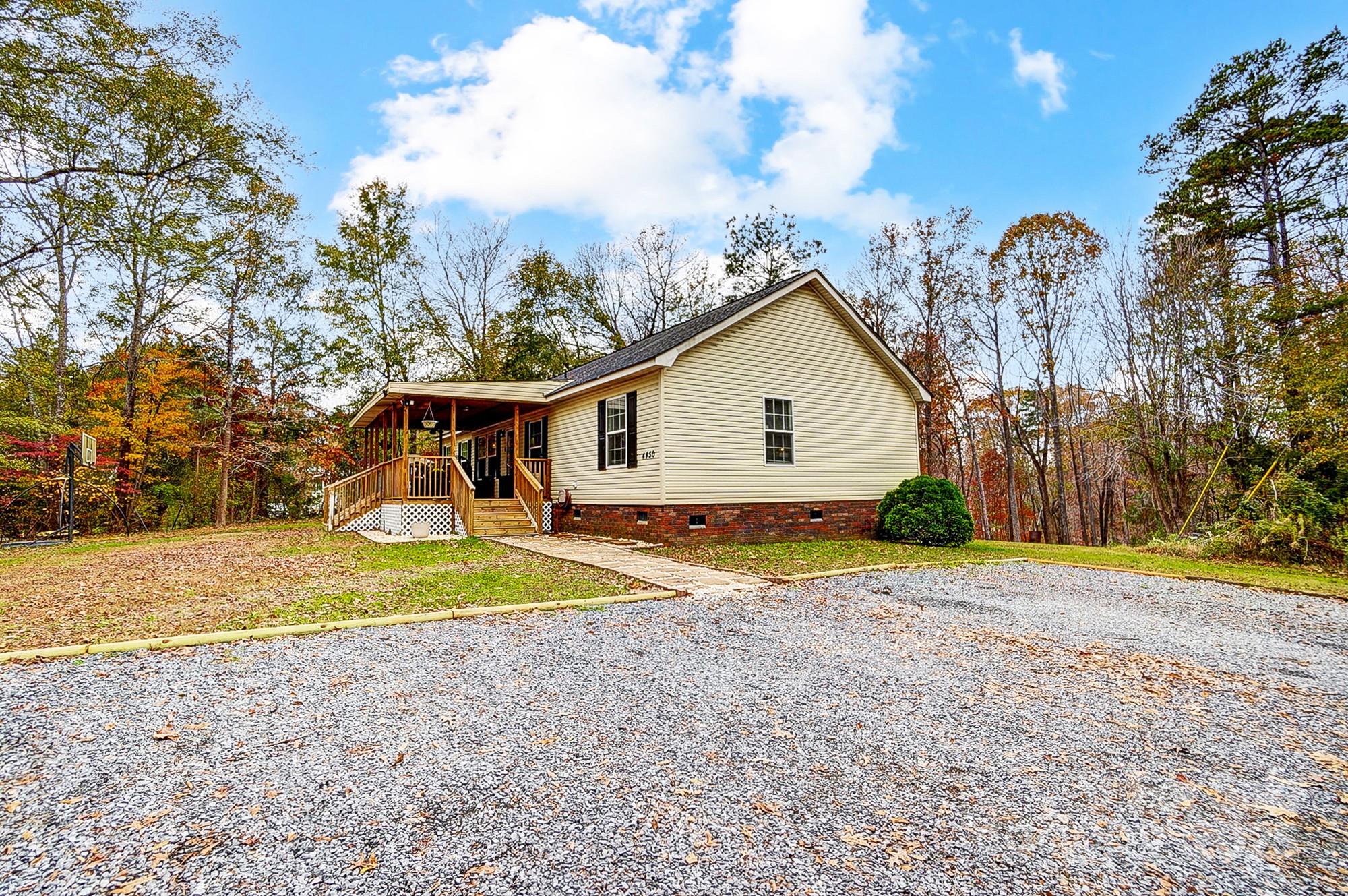 4450 Dobys Bridge Road Fort Mill, SC 29707 - Photo 3 of 45 a view of a house with a yard and a large tree