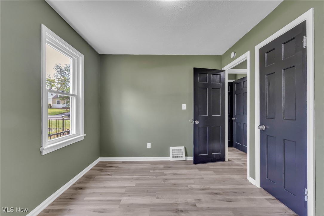20813 Hansen Road Maple Heights, OH 44137 - Photo 20 of 40 Unfurnished bedroom with light wood-style floors and baseboards