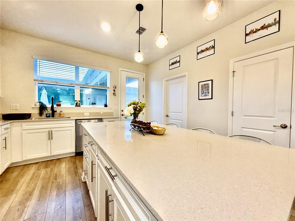 2208 Gopher Tortoise Terrace Oakland, FL 34787 - Photo 13 of 50 a kitchen that has a lot of cabinets and wooden floor
