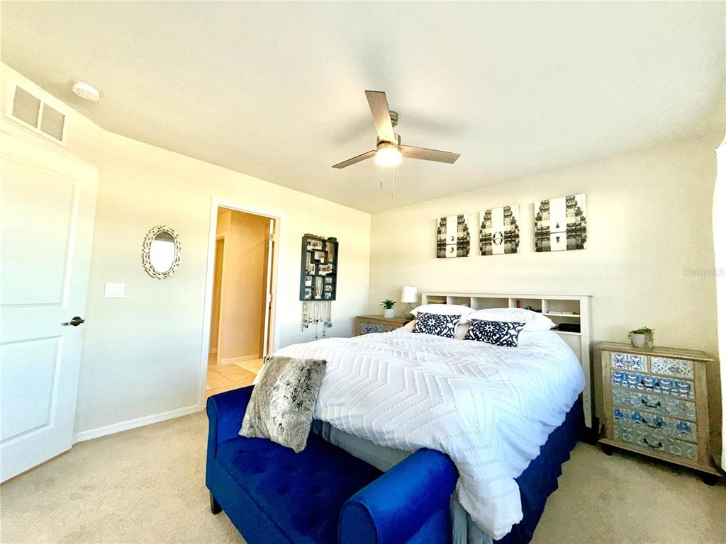 2208 Gopher Tortoise Terrace Oakland, FL 34787 - Photo 24 of 50 a bedroom with a bed and a night stand